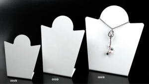 White plexiglass necklace display